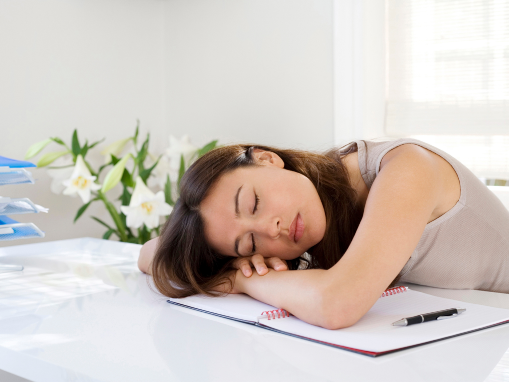 Exhausted woman sleeping at her desk