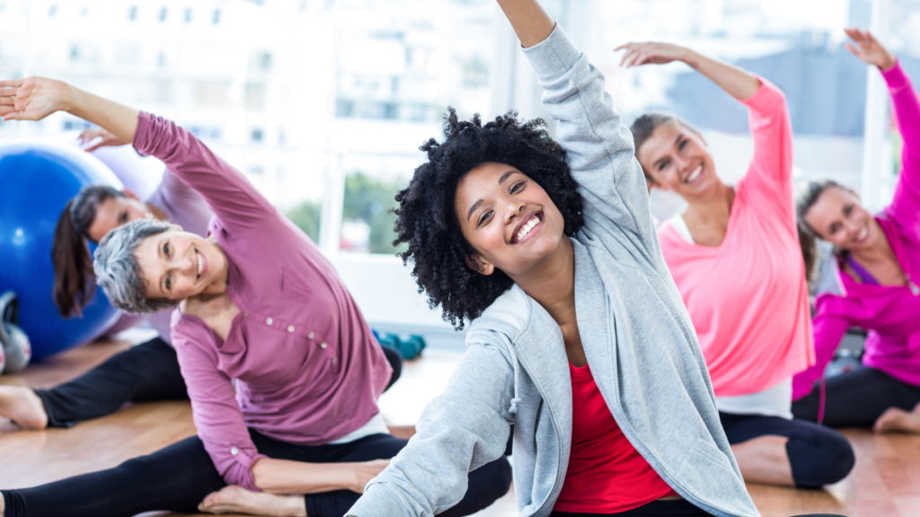 A group of women stretching in a group exercise class