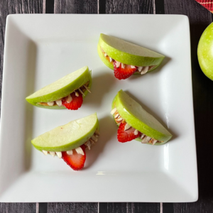 A plate with healthy apple monster mouth snacks on it