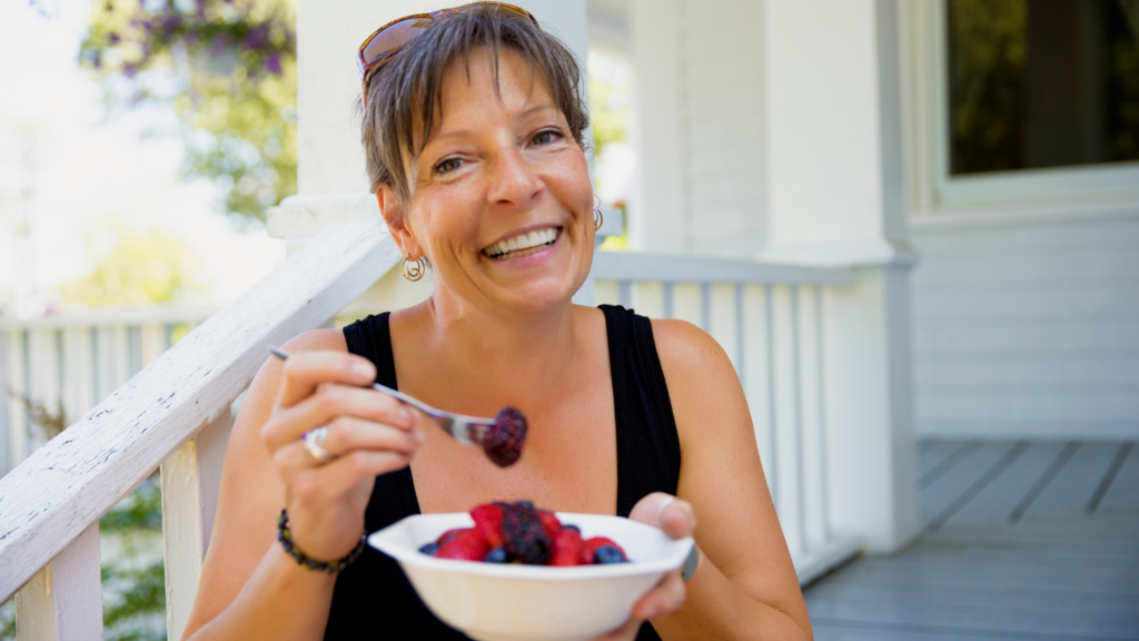 Woman eating a bowl of berries